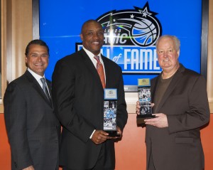 Magic CEO Alex Martins (left) unveiled the Magic's inaugural Hall of Fame class on April 9 naming the first two inductees, Magic co-founder and Senior Vice President Pat Williams (right) and the team’s first-ever draft pick and current Community Ambassador Nick Anderson (center). The Magic Hall of Fame will honor and celebrate the great players, coaches and executives who have had a major impact during the team’s illustrious 25-year history. Photo taken by Fernando Medina.